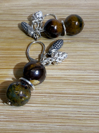 Earrings with round Brown Opal and Pietersite stones, finished with detailed silver pine cone and corn cob motifs. Styled as earthy, fall-inspired jewelry.