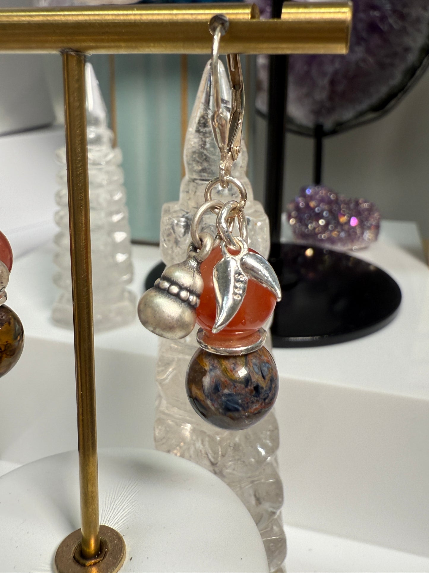 Pair of crystal earrings combining South Red Agate and Pietersite, with silver bamboo leaf and gourd details. Photographed as warm, harvest-themed jewelry.