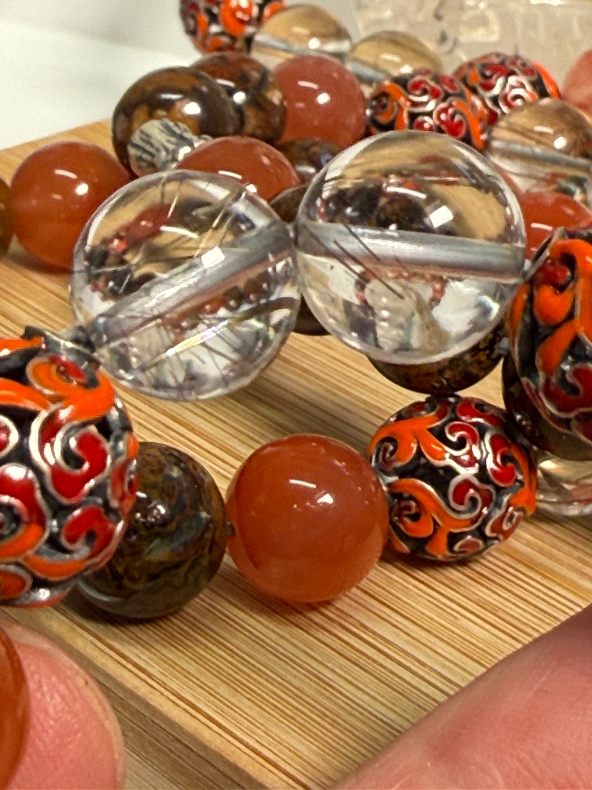 Crystal bracelet featuring South Red Agate, Pietersite, Rutile-in-Quartz, and Brown Opal, with 925 sterling silver cabbage and enameled beads, accented by a clear quartz ring. A sculptural fine jewelry piece symbolizing growth, clarity, and inner resilience.